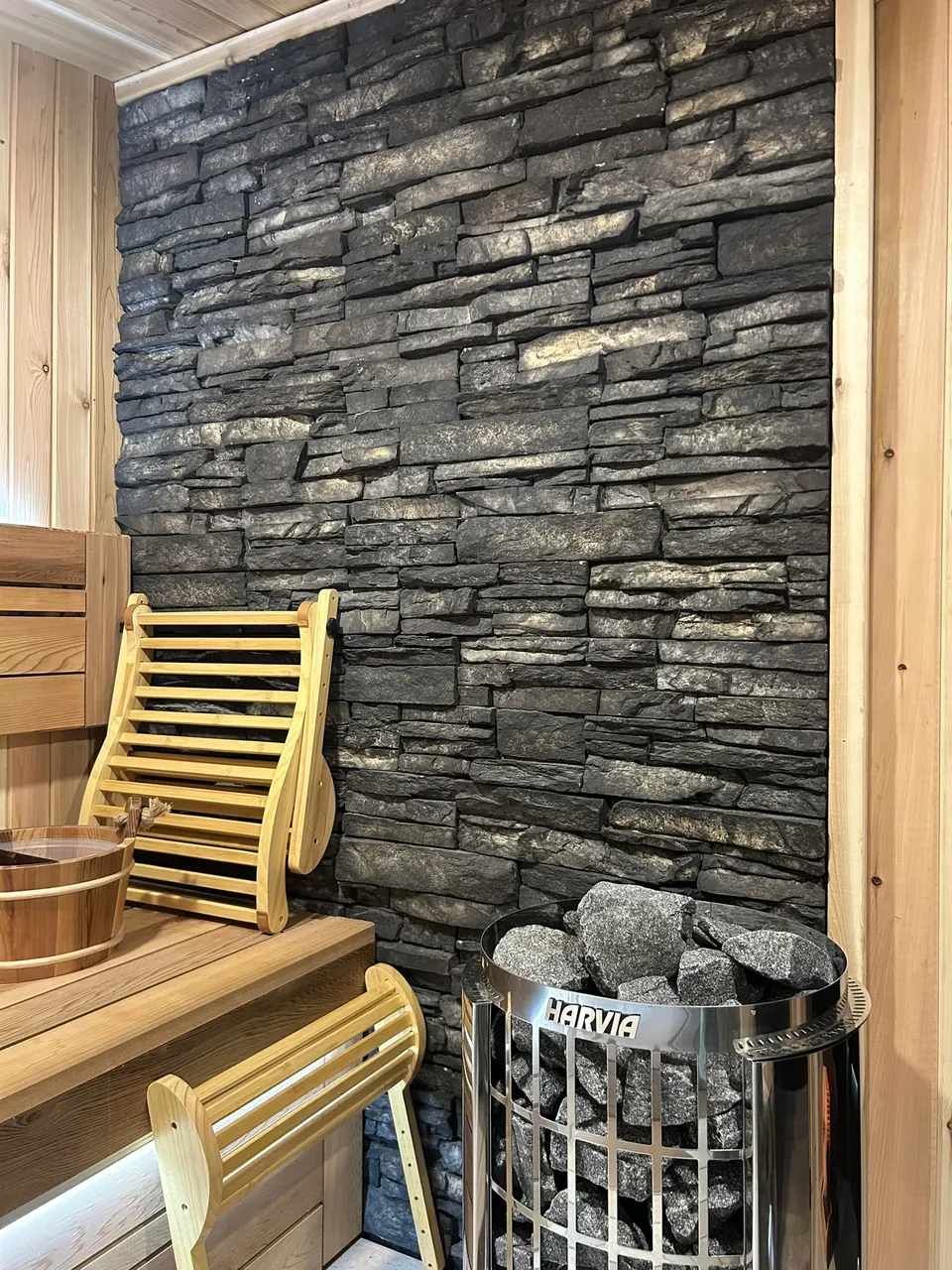 Backyard sauna: stone-backed heater and bench accessories