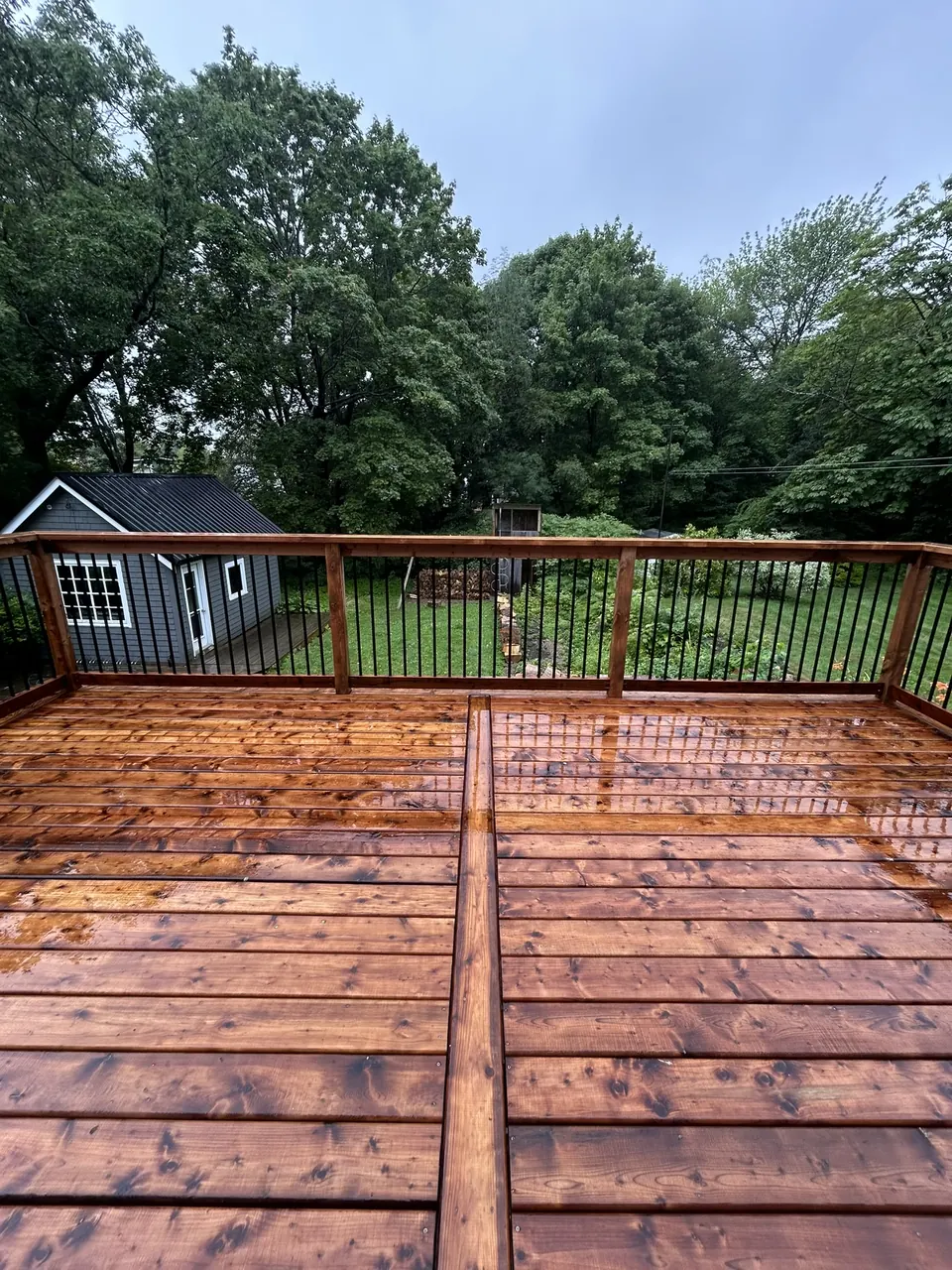 Raised wood deck: decorative deck boards and black balusters