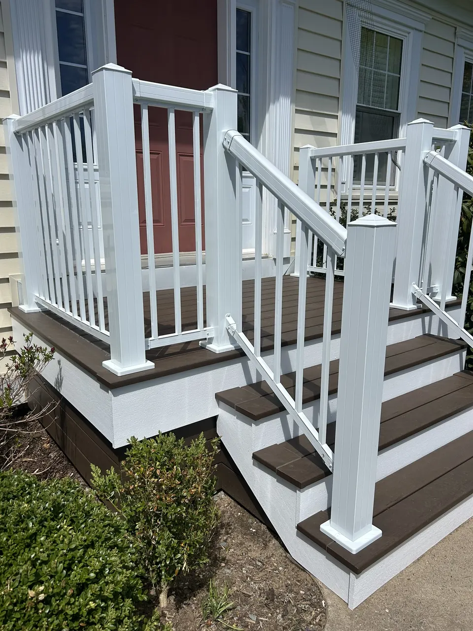 Red-door front entry: front stairs and landscaped edge