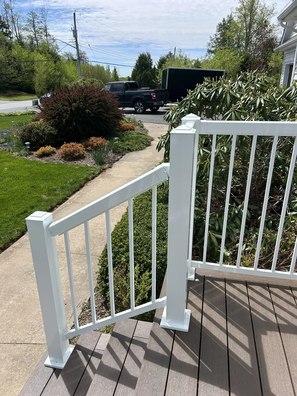 Red-door front entry: landing railing looking toward the path