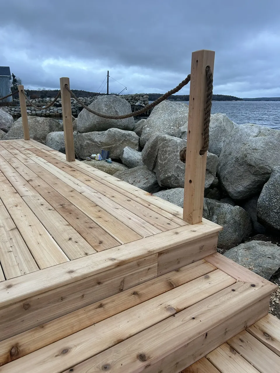 Waterfront wood platform: shoreline steps and rope edging